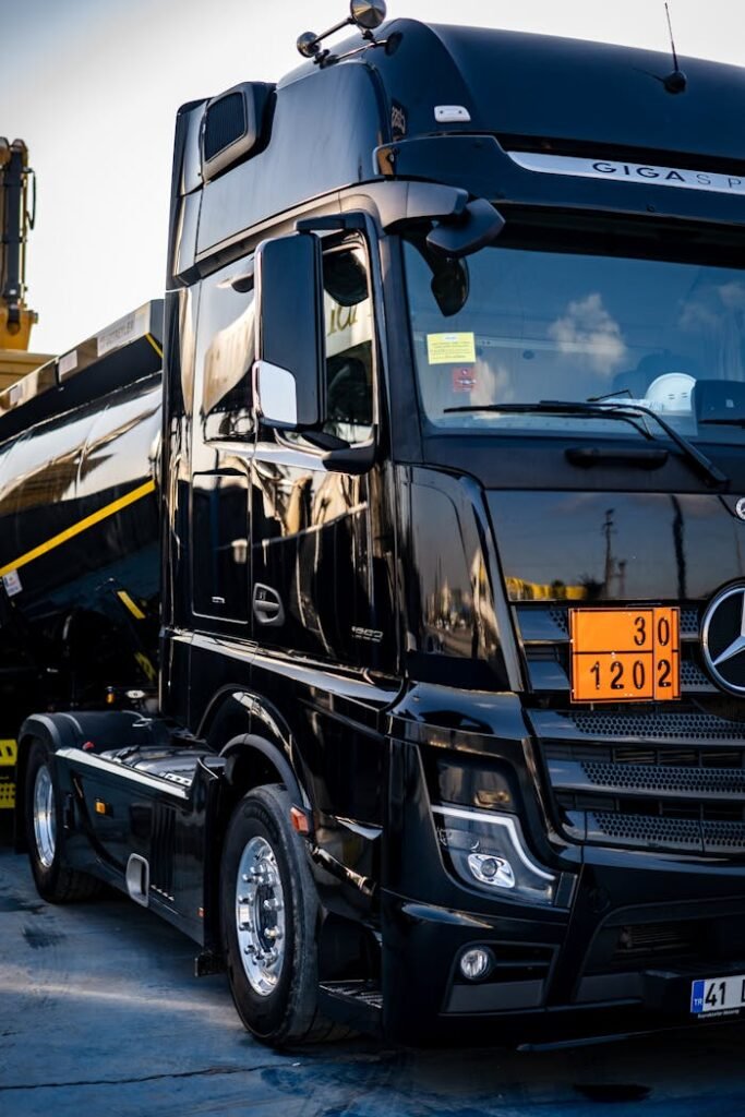pexels photo 16100082 Black truck with a tanker, showcasing logistics and transportation in an industrial environment.